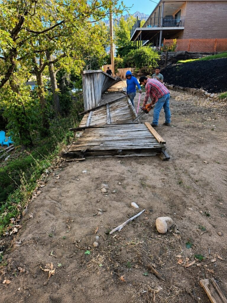 Amigos crew clearing an old fence line on a Heber Valley property