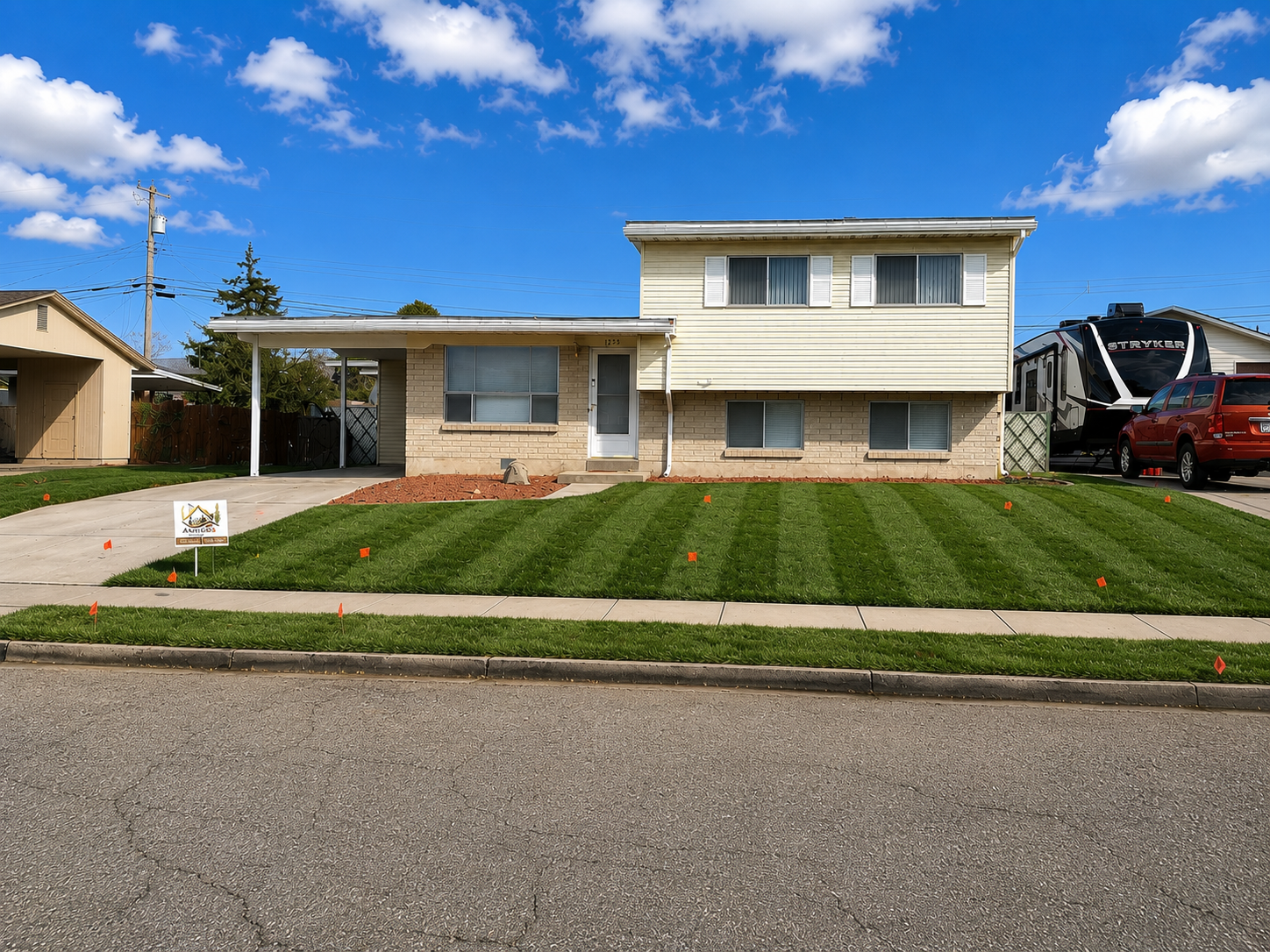 Freshly installed and striped front lawn, Amigos landscape transformation in Heber City, Utah