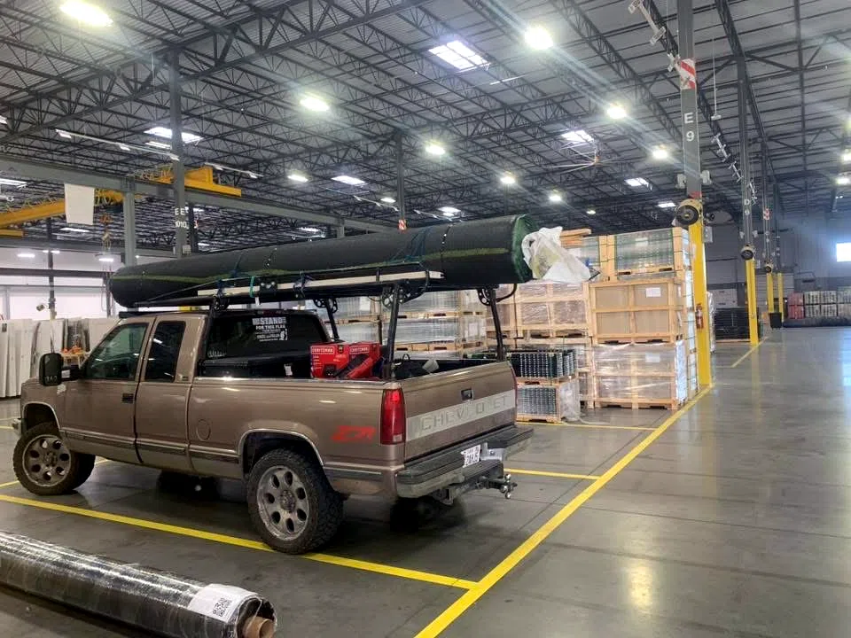 Amigos work truck loaded with equipment at a commercial facility