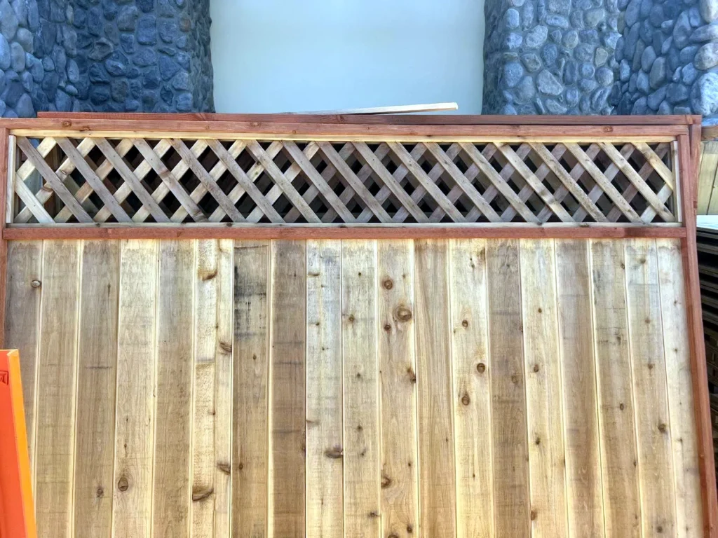 Newly stained cedar fence with lattice topper at a Heber City property