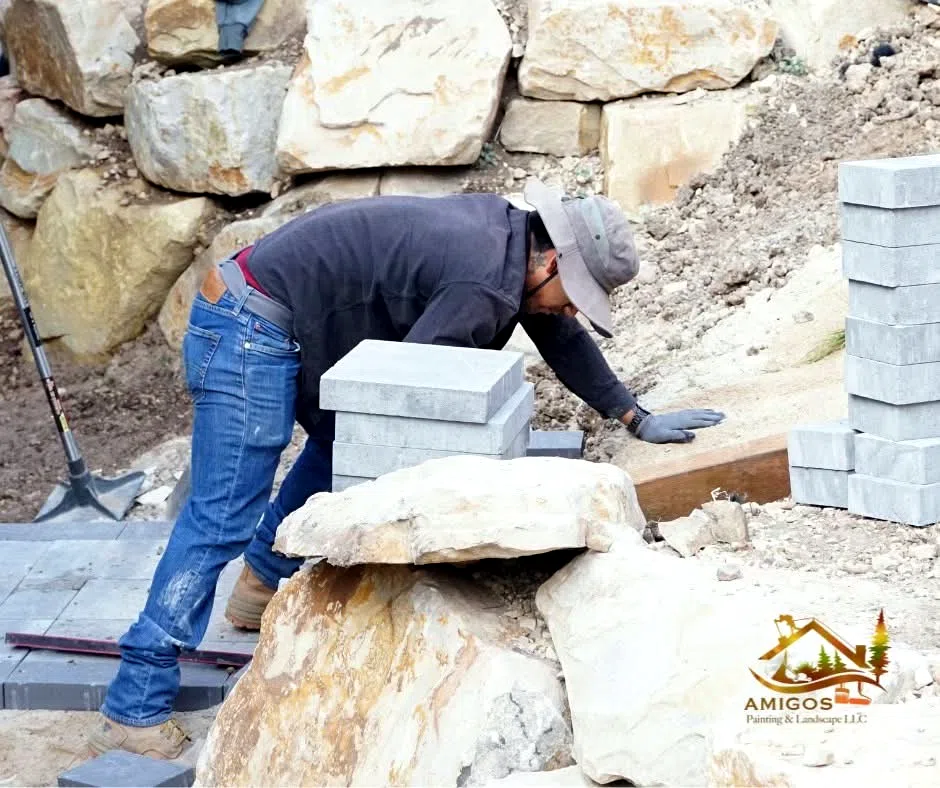 Crew member setting a block course by hand against stone