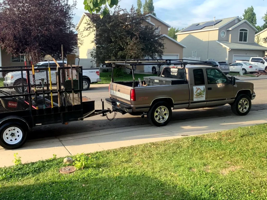 Amigos truck and loaded equipment trailer at a Heber Valley jobsite