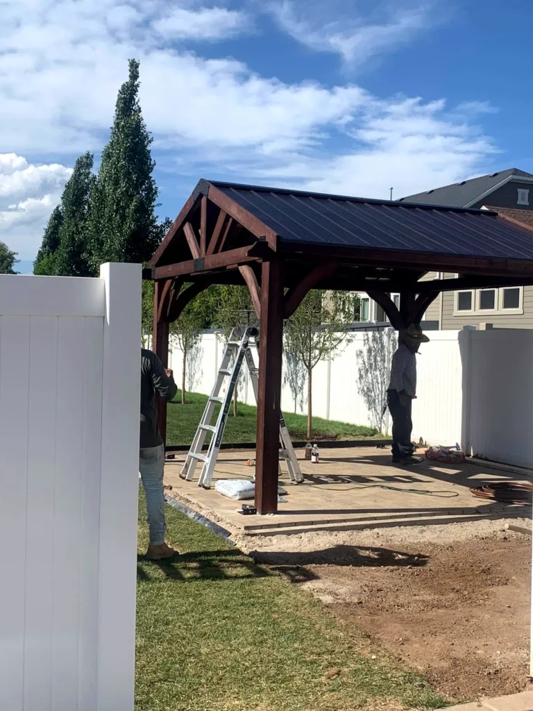 Crew assembling a timber pergola frame on site
