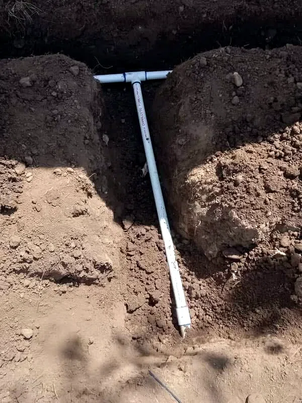 Irrigation line set in a hand-dug trench before backfill