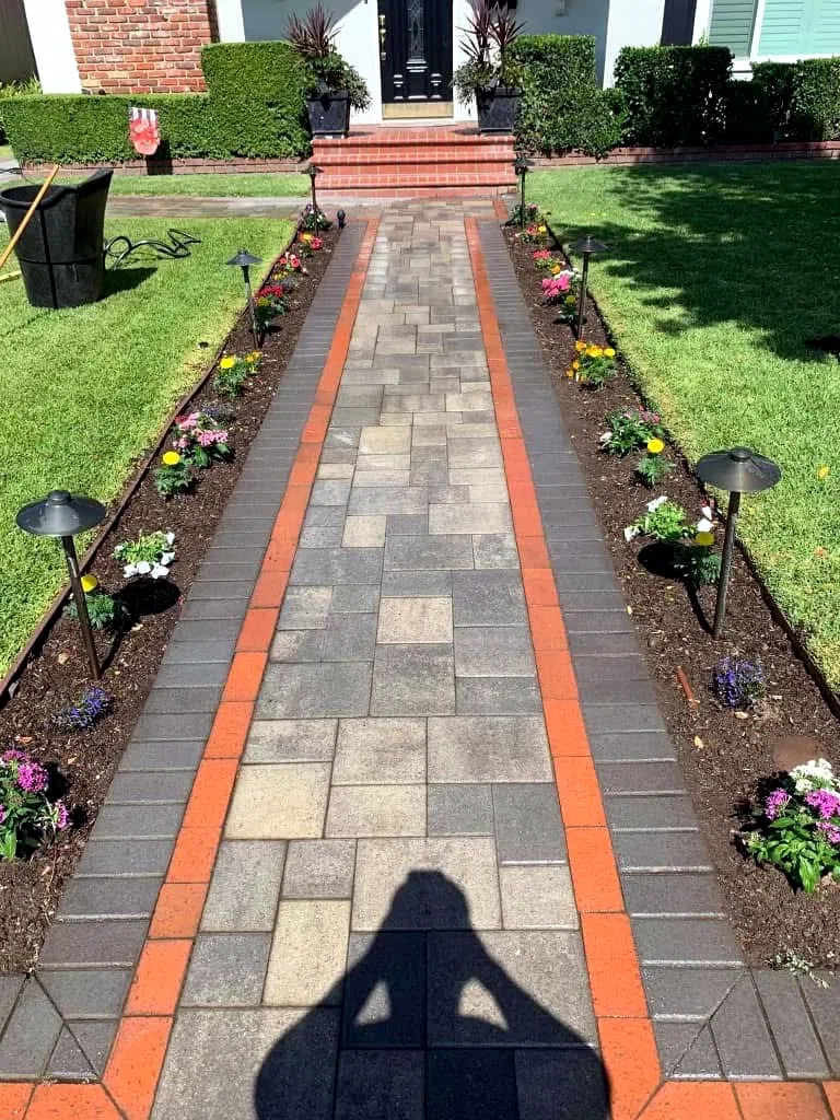 Paver walkway with contrasting border banding leading to a home entry