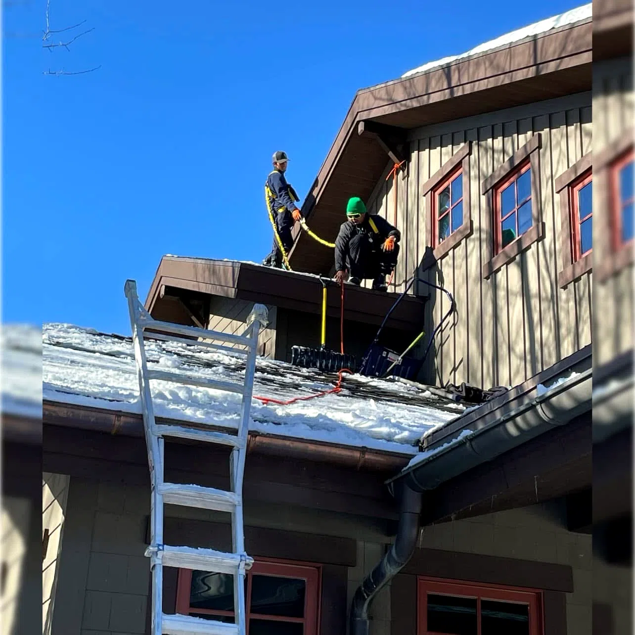 Amigos crew clearing heavy snow from a steep roof in Heber Valley, Utah